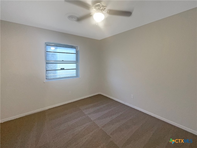 carpeted spare room featuring ceiling fan