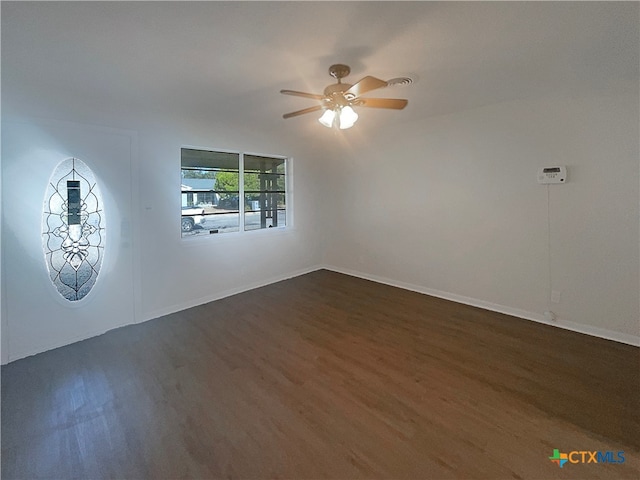 unfurnished room with dark hardwood / wood-style flooring and ceiling fan