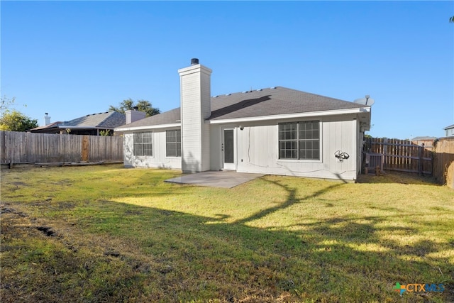 rear view of house featuring a patio area and a yard