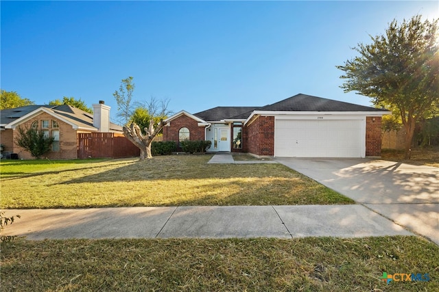 single story home with a garage and a front lawn