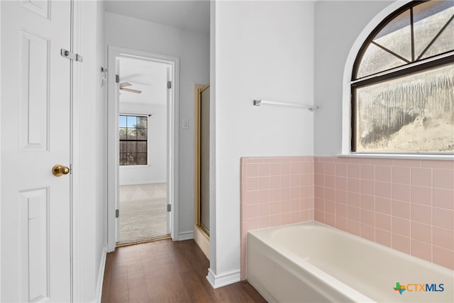 bathroom featuring wood-type flooring, ceiling fan, and independent shower and bath