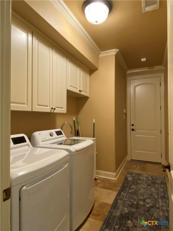 laundry area with cabinet space, ornamental molding, washing machine and dryer, baseboards, and visible vents