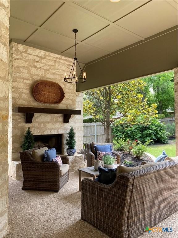 view of patio / terrace featuring fence and an outdoor living space with a fireplace