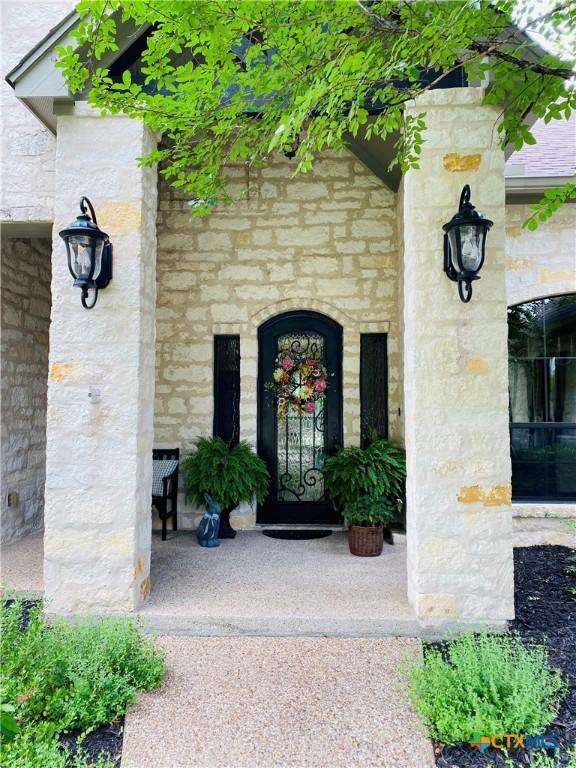 doorway to property with stone siding