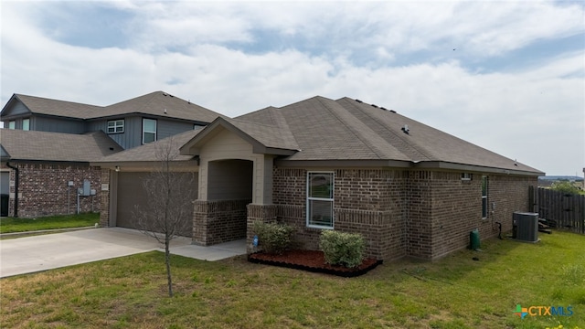 6505 Cassidy Ln, Killeen, TX 76542 - view of front of property with a garage, driveway, brick siding, and central AC