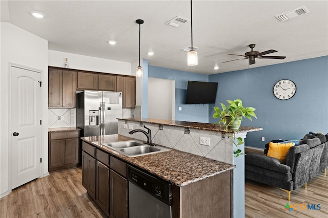 6505 Cassidy Ln, Killeen, TX 76542 - kitchen featuring appliances with stainless steel finishes, open floor plan, a sink, light wood-style floors, and recessed lighting
