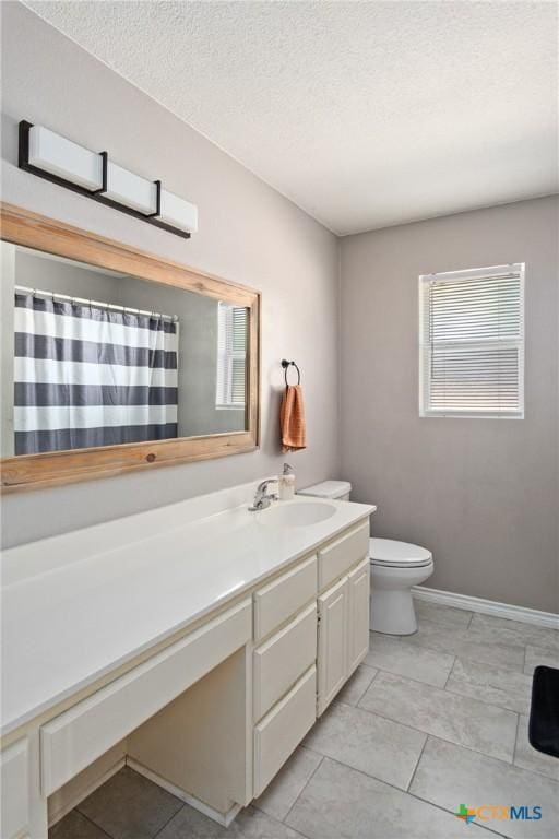 bathroom featuring vanity, toilet, a textured ceiling, and walk in shower