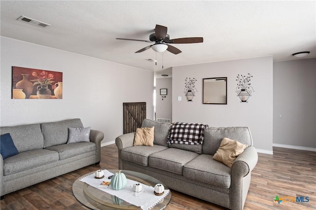 living room with ceiling fan and wood-type flooring