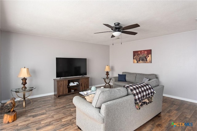 living room with ceiling fan and dark hardwood / wood-style flooring