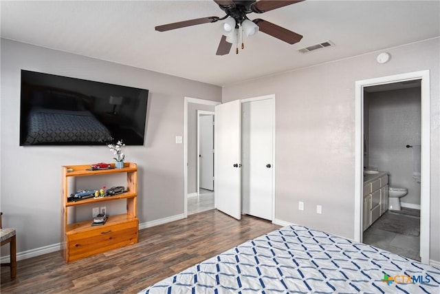 bedroom featuring ensuite bath, ceiling fan, and dark wood-type flooring