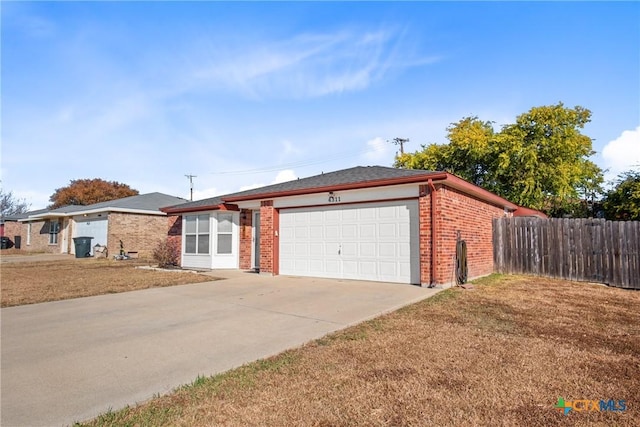 ranch-style house featuring a front yard and a garage