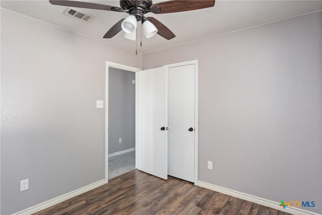 unfurnished bedroom featuring dark hardwood / wood-style flooring and ceiling fan