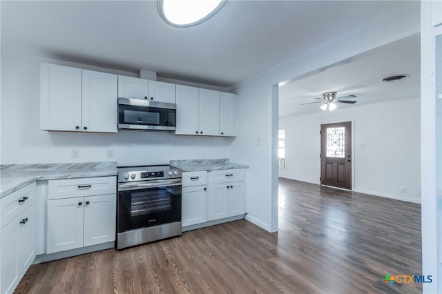 kitchen with ceiling fan, light stone countertops, white cabinetry, and appliances with stainless steel finishes