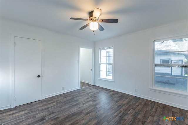 empty room featuring ceiling fan and dark hardwood / wood-style flooring