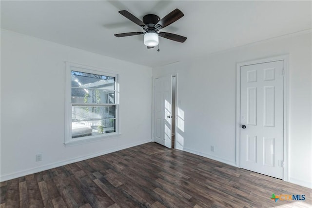 empty room with ceiling fan and dark hardwood / wood-style floors