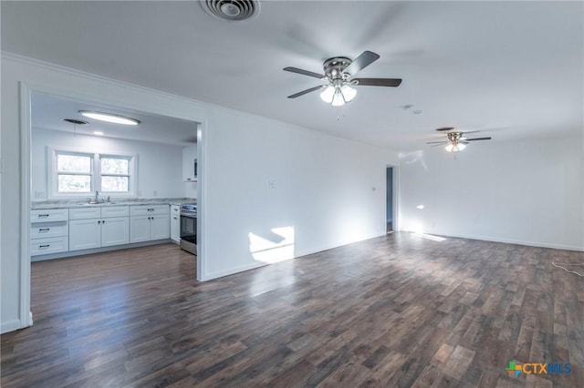 unfurnished living room with dark hardwood / wood-style flooring, ceiling fan, and sink