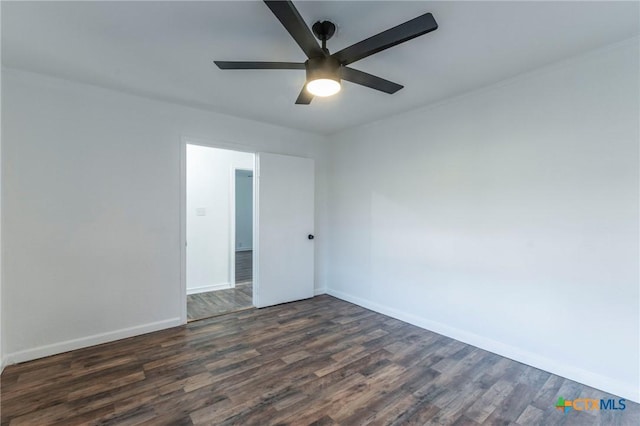 spare room featuring ceiling fan and dark wood-type flooring