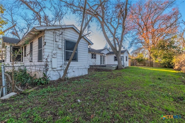 view of side of home featuring a lawn