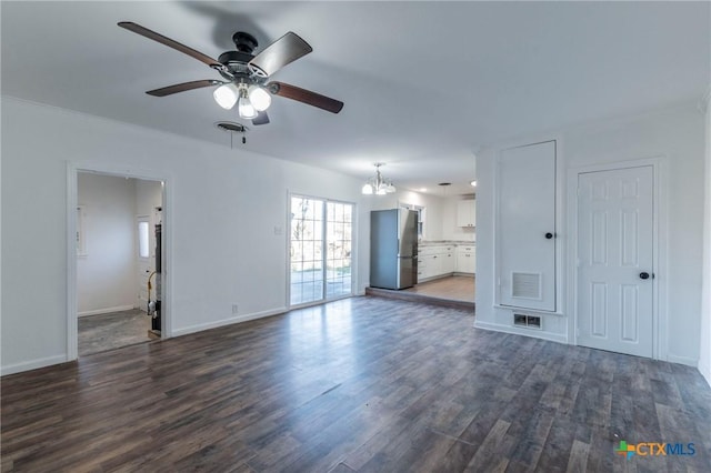 unfurnished living room with dark hardwood / wood-style floors and ceiling fan with notable chandelier