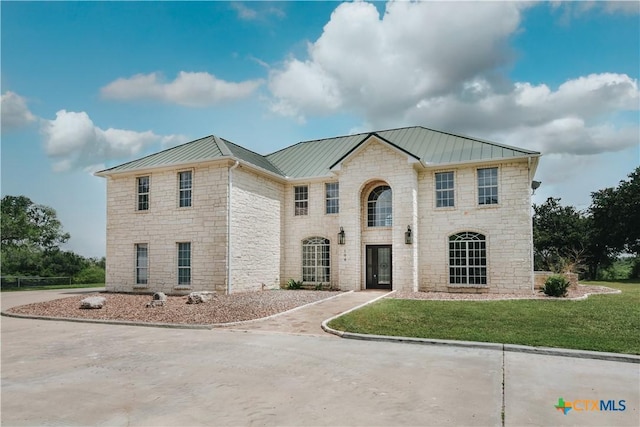 194 Panorama Ln, Victoria, TX 77905 - view of front of home with stone siding, a standing seam roof, metal roof, and a front yard