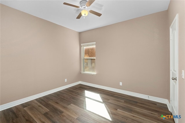 empty room featuring dark wood-type flooring, baseboards, and ceiling fan