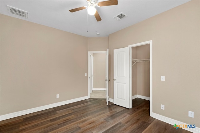 unfurnished bedroom featuring visible vents, baseboards, and dark wood-style floors