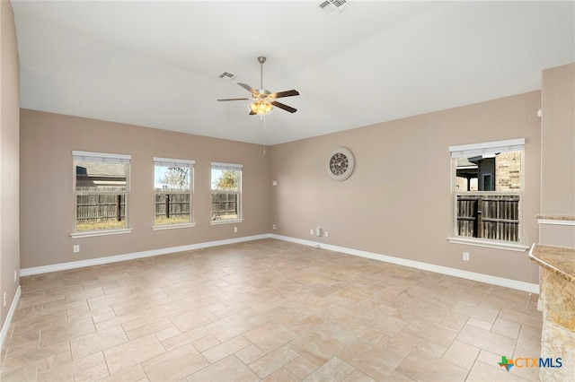 spare room with visible vents, baseboards, and ceiling fan