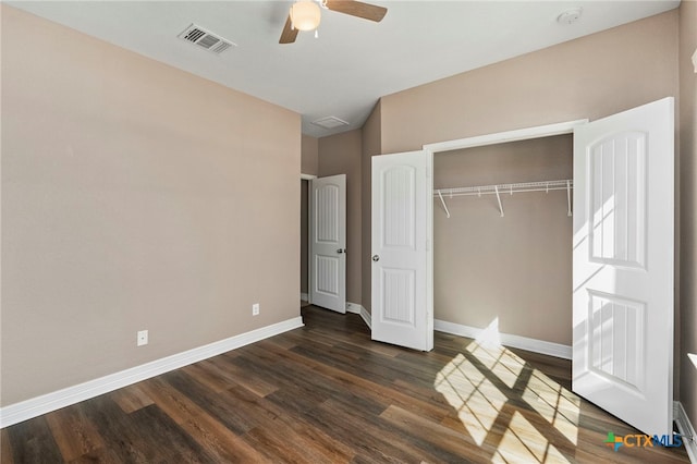 unfurnished bedroom with visible vents, dark wood-type flooring, a ceiling fan, a closet, and baseboards