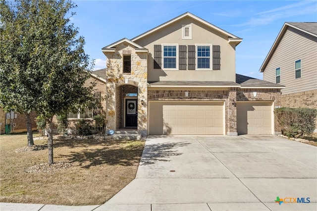 traditional-style home featuring brick siding, stucco siding, a garage, stone siding, and driveway