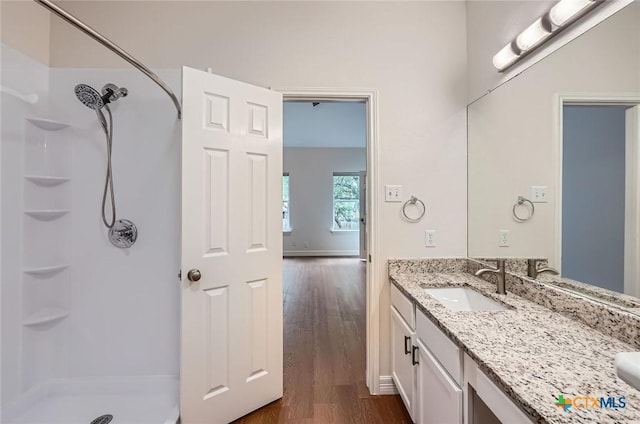 2033 Northview Dr, San Marcos, TX 78666 - bathroom featuring a shower, vanity, and wood finished floors