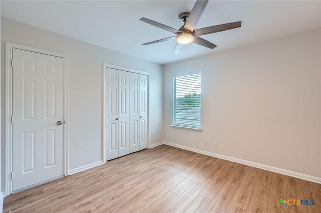 2033 Northview Dr, San Marcos, TX 78666 - unfurnished bedroom with light wood finished floors, a closet, and a ceiling fan