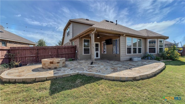 back of house with a fire pit, fence, a yard, a patio area, and a ceiling fan