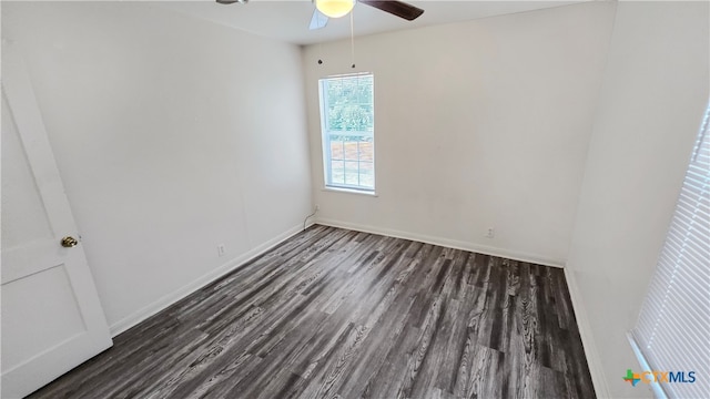 spare room with dark wood-type flooring and ceiling fan