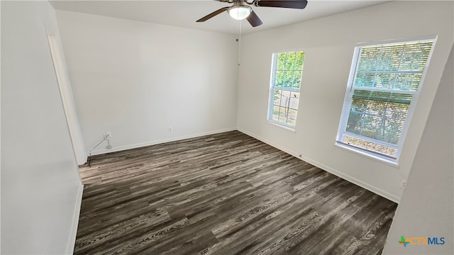 empty room with dark hardwood / wood-style flooring and ceiling fan