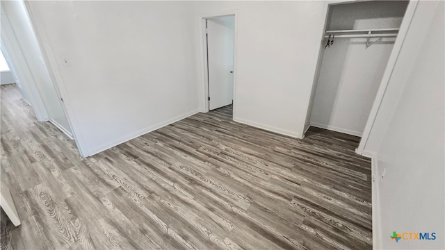 unfurnished bedroom with a closet and light hardwood / wood-style flooring