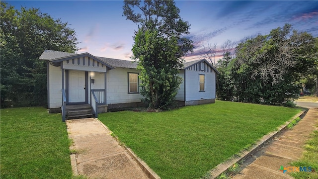 view of front of property with a yard