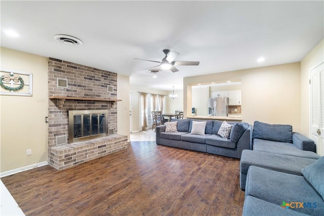 204 W Johnson St, Cuero, TX 77954 - living room with ceiling fan, wood finished floors, a brick fireplace, and recessed lighting