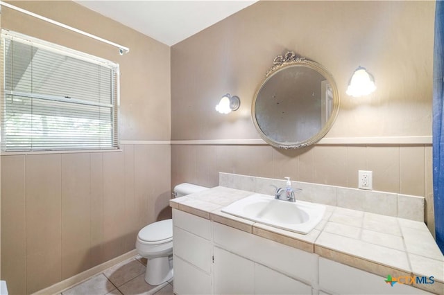 204 W Johnson St, Cuero, TX 77954 - bathroom with vanity, tile patterned flooring, and a wainscoted wall