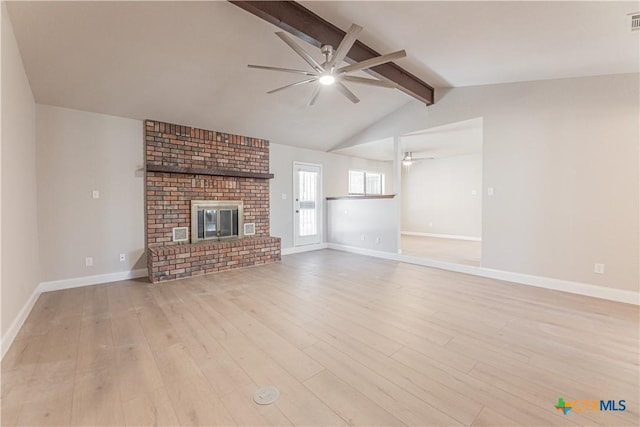 unfurnished living room with a fireplace, light wood finished floors, lofted ceiling with beams, a ceiling fan, and baseboards