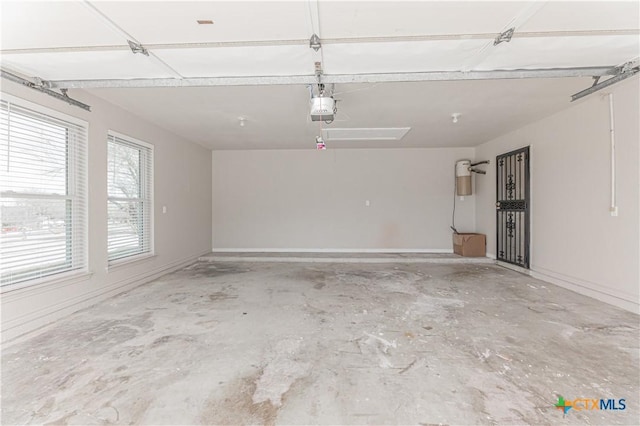 parking deck with baseboards and a garage door opener