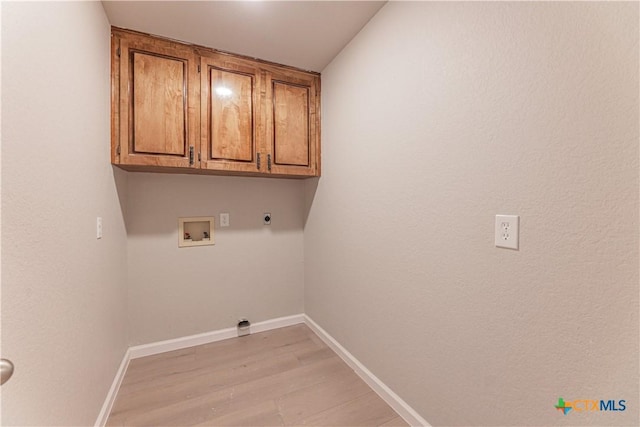 laundry area featuring hookup for a washing machine, cabinet space, baseboards, and hookup for an electric dryer