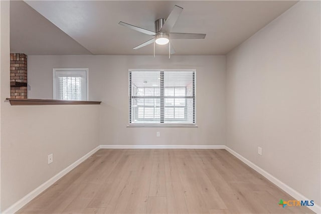 unfurnished room with a ceiling fan, light wood-type flooring, and baseboards