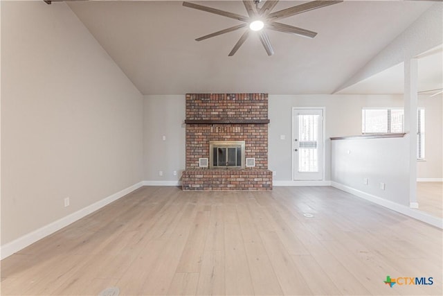 unfurnished living room with baseboards, a ceiling fan, light wood-style flooring, vaulted ceiling, and a fireplace