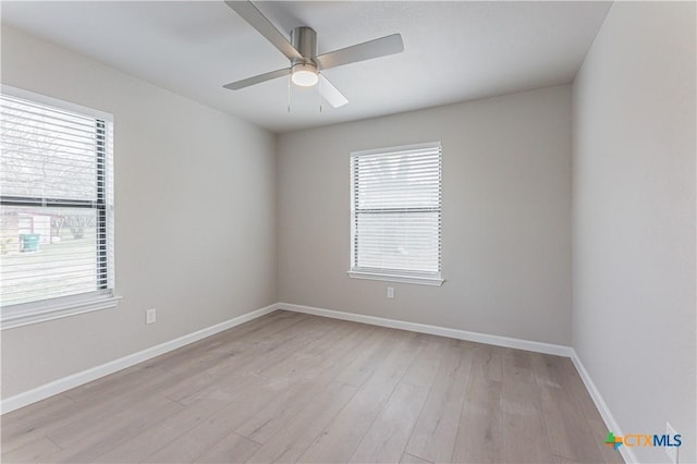 unfurnished room featuring baseboards, ceiling fan, and light wood-style floors