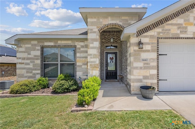 1442 Neff Dr, Copperas Cove, TX 76522 - doorway to property featuring stone siding, a garage, and a lawn