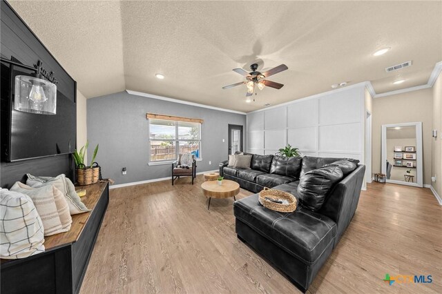 1442 Neff Dr, Copperas Cove, TX 76522 - living area featuring ceiling fan, light wood finished floors, lofted ceiling, crown molding, and a textured ceiling