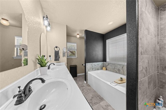 1442 Neff Dr, Copperas Cove, TX 76522 - full bathroom featuring a bath, double vanity, tile patterned floors, and a textured ceiling