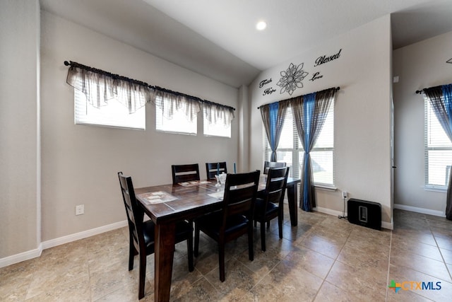 dining area featuring vaulted ceiling