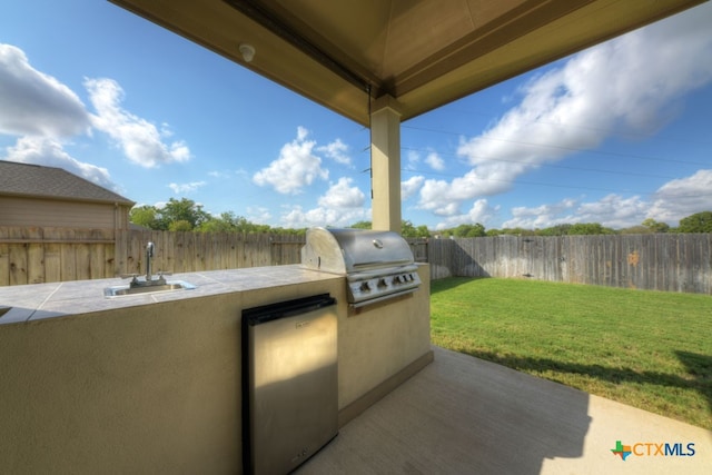 view of patio / terrace with area for grilling, sink, and exterior kitchen