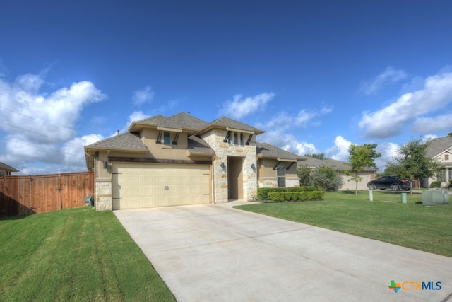 view of front of property featuring a garage and a front lawn